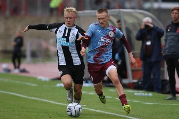 Jack Young of Newcastle United battles for possession with Danny Greenfield of Gateshead during the Pre-season Friendly match between Gateshead and...