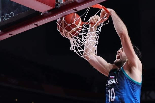 Slovenia's Mike Tobey scores a basket in the men's preliminary round group C basketball match between Spain and Slovenia during the Tokyo 2020...