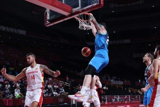 Slovenia's Ziga Dimec scores a basket as Spain's Willy Hernangomez Geuer watches in the men's preliminary round group C basketball match between...