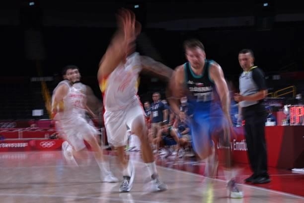 Slovenia's Luka Doncic runs with the ball past Spain's players in the men's preliminary round group C basketball match between Spain and Slovenia...