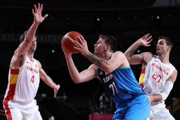 Slovenia's Luka Doncic shoots the ball past Spain's Pau Gasol Saez and Alberto Abalde in the men's preliminary round group C basketball match between...