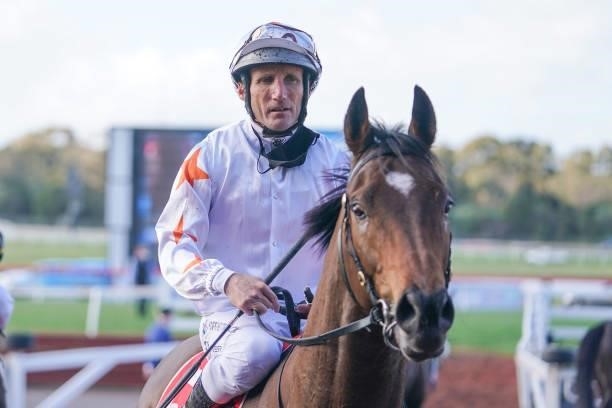 Invincible Jet ridden by Damien Oliver returns to the mounting yard after winning the Ladbrokes Easy Form Handicap at Ladbrokes Park Lakeside...