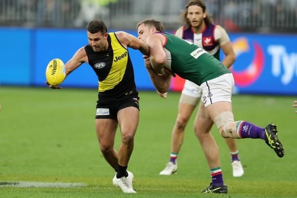 Jack Graham of the Tigers is tackled by Sean Darcy of the Dockers during the 2021 AFL Round 20 match between the Fremantle Dockers and the Richmond...