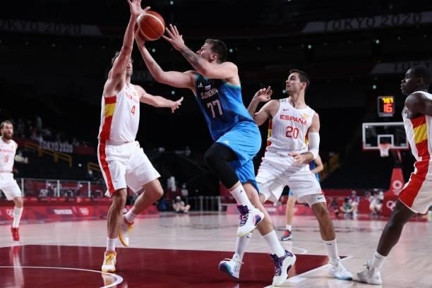 Spain's Pau Gasol Saez fights for the ball with Slovenia's Luka Doncic in the men's preliminary round group C basketball match between Spain and...