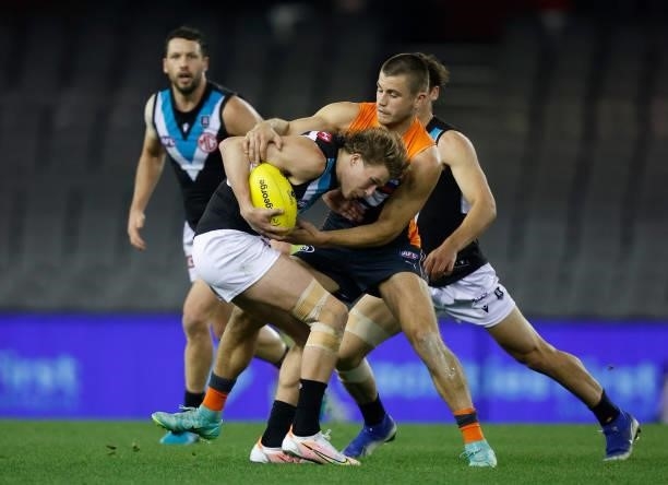 Xavier Duursma of the Power is tackled by Xavier O'Halloran of the Giants during the 2021 AFL Round 20 match between the GWS Giants and the Port...