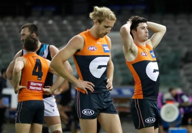 Nick Haynes and Lachie Ash of the Giants look dejected after a loss during the 2021 AFL Round 20 match between the GWS Giants and the Port Adelaide...