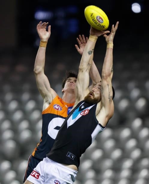 Charlie Dixon of the Power and Sam Taylor of the Giants compete for the ball during the 2021 AFL Round 20 match between the GWS Giants and the Port...