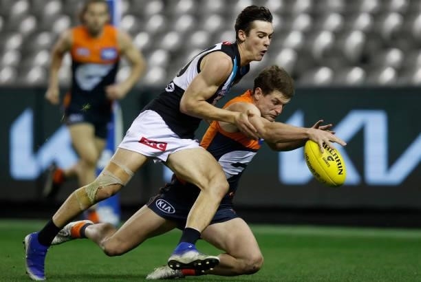 Connor Rozee of the Power and Jacob Hopper of the Giants in action during the 2021 AFL Round 20 match between the GWS Giants and the Port Adelaide...