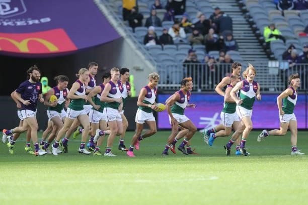 The Dockers run out onto the field during the 2021 AFL Round 20 match between the Fremantle Dockers and the Richmond Tigers at Optus Stadium on...