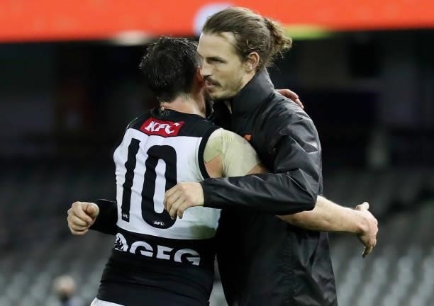 Travis Boak of the Power and Phil Davis of the Giants embrace after the 2021 AFL Round 20 match between the GWS Giants and the Port Adelaide Power at...
