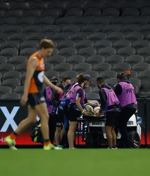 Jacob Hopper of the Giants leaves the field on a stretcher during the 2021 AFL Round 20 match between the GWS Giants and the Port Adelaide Power at...