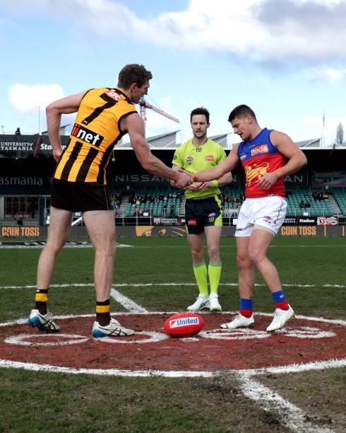 Ben McEvoy of the Hawks and Dayne Zorko of the Lions shake hands at the coin toss during the 2021 AFL Round 20 match between the Hawthorn Hawks and...