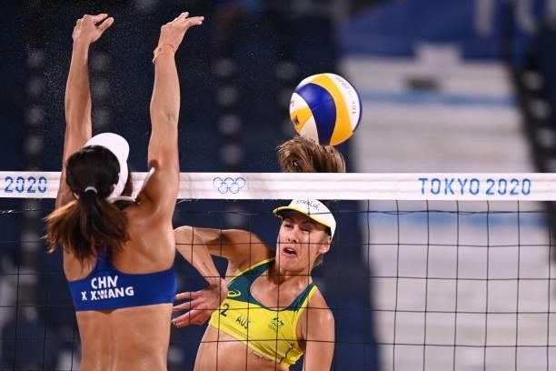 Australia's Taliqua Clancy attempts a shot past China's Wang Xinxin in their women's beach volleyball round of 16 match between Australia and China...