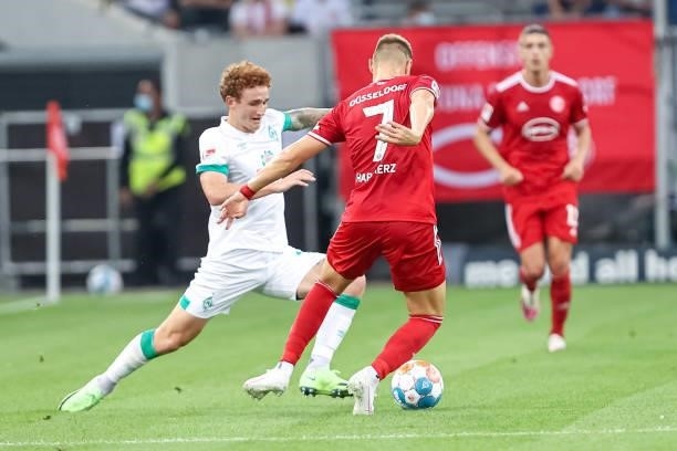 Josh Sargent of SV Werder Bremen and Florian Hartherz of Fortuna Duesseldorf battle for the Ball during the Second Bundesliga match between Fortuna...