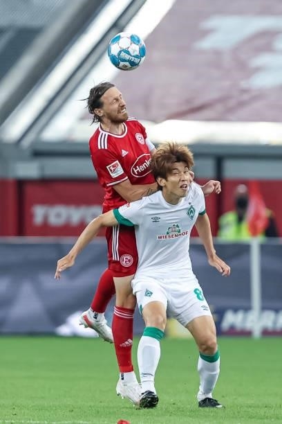 Adam Bodzek of Fortuna Duesseldorf and Yuya Osako of SV Werder Bremen battle for the Ball during the Second Bundesliga match between Fortuna...