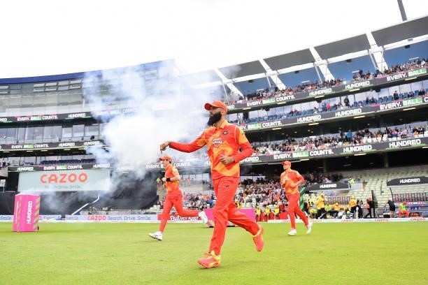 Moeen Ali of the Birmingham Phoenix leads his team out to field during The Hundred match between Birmingham Phoenix Men and Trent Rockets Men at...