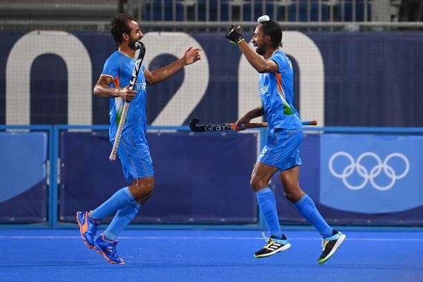 India's Hardik Singh celebrates with a teammate after scoring against Britain during their men's quarter-final match of the Tokyo 2020 Olympic Games...