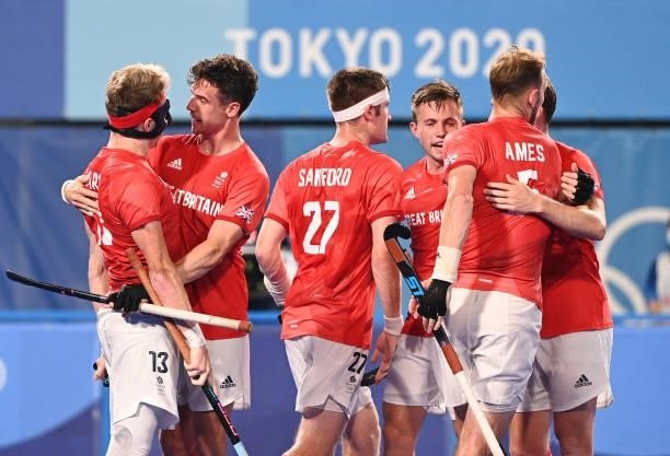 Britain's Samuel Ian Ward celebrates with teammates after scoring against India during their men's quarter-final match of the Tokyo 2020 Olympic...