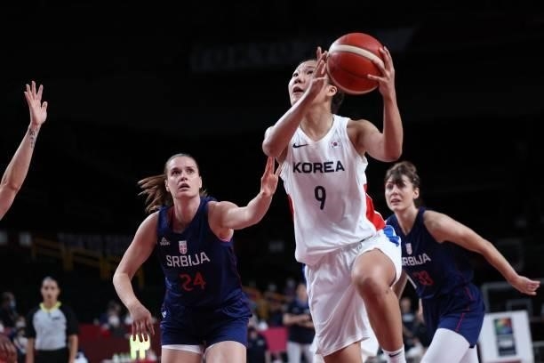 South Korea's Park Jihyun goes to the basket as Serbia's Maja Skoric and Tina Krajisnik watch in the women's preliminary round group A basketball...