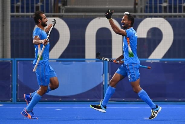 India's Hardik Singh celebrates with a teammate after scoring against Britain during their men's quarter-final match of the Tokyo 2020 Olympic Games...