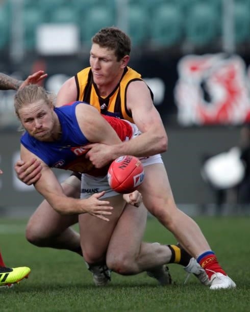 Daniel Rich of the Lions is tackled by Ben McEvoy of the Hawks during the 2021 AFL Round 20 match between the Hawthorn Hawks and the Brisbane Lions...
