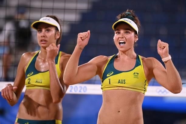Australia's Mariafe Artacho del Solar and partner Taliqua Clancy celebrate winning their women's beach volleyball round of 16 match between Australia...
