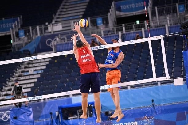 Netherlands' Alexander Brouwer attempts a shot past Norway's Anders Berntsen Mol in their men's beach volleyball round of 16 match between Norway and...