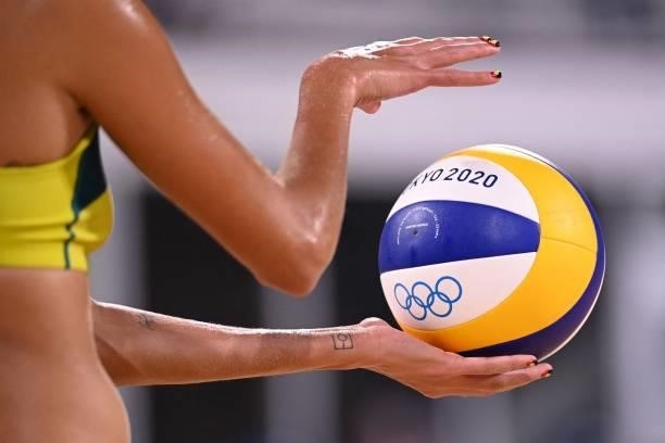Australia's Taliqua Clancy prepares to serve in their women's beach volleyball round of 16 match between Australia and China during the Tokyo 2020...