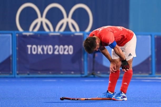 Britain's Adam Graham Dixon reacts after losing 3-1 to India in their men's quarter-final match of the Tokyo 2020 Olympic Games field hockey...