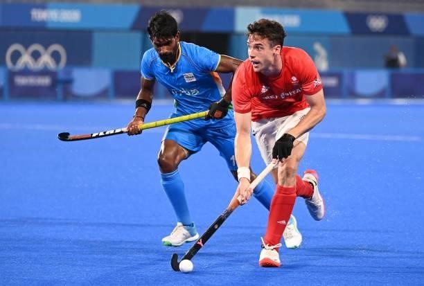 Britain's Phillip Roper is challenged by India's Sumit during their men's quarter-final match of the Tokyo 2020 Olympic Games field hockey...