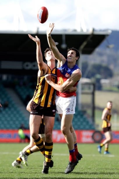 Oscar McInerney of the Lions and Ned Reeves of the Hawks compete in a ruck contest during the 2021 AFL Round 20 match between the Hawthorn Hawks and...