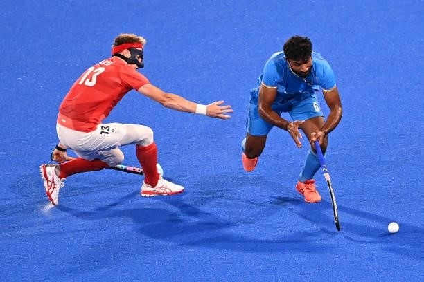 India's Surender Kumar is challenged by Britain's Samuel Ian Ward during their men's quarter-final match of the Tokyo 2020 Olympic Games field hockey...