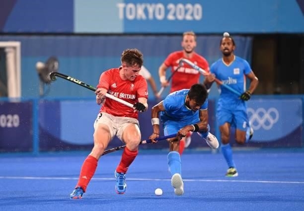 Britain's Thomas Sorsby and India's Vivek Sagar Prasad vie for the ball during their men's quarter-final match of the Tokyo 2020 Olympic Games field...