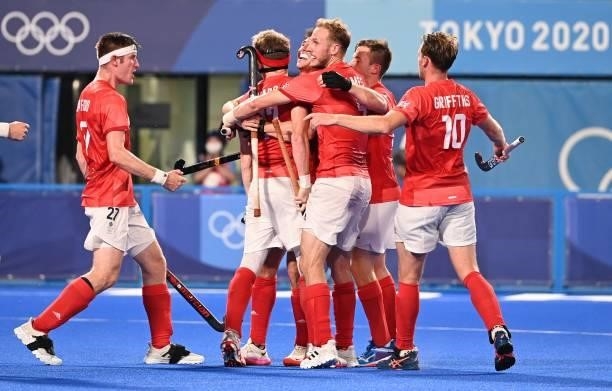 Britain's Samuel Ian Ward celebrates with teammates after scoring against India during their men's quarter-final match of the Tokyo 2020 Olympic...