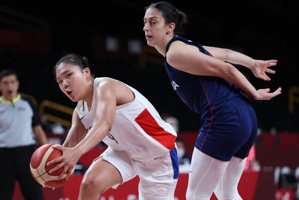 South Korea's Park Jihyun runs with the ball past Serbia's Jelena Brooks in the women's preliminary round group A basketball match between South...