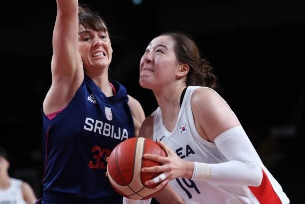 South Korea's Park Ji Su handles the ball past Serbia's Tina Krajisnik in the women's preliminary round group A basketball match between South Korea...