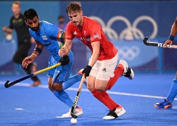 Britain's Liam Paul Ansell is challenged by India's Manpreet Singh during their men's quarter-final match of the Tokyo 2020 Olympic Games field...