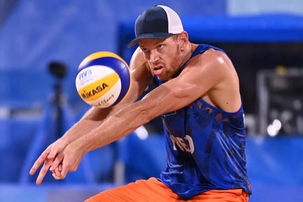 Netherlands' Alexander Brouwer digs the ball in their men's beach volleyball round of 16 match between Norway and the Netherlands during the Tokyo...