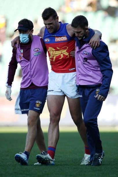 Jack Payne of the Lions leaves the field injured during the 2021 AFL Round 20 match between the Hawthorn Hawks and the Brisbane Lions at UTAS Stadium...