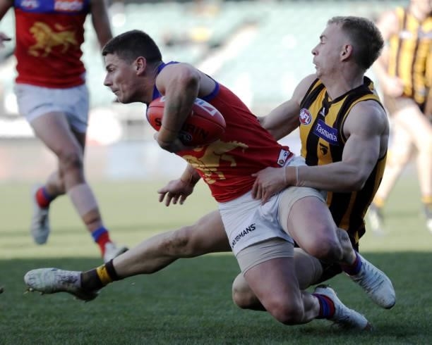 Dayne Zorko of the Lions is tackled by James Worpel of the Hawks during the 2021 AFL Round 20 match between the Hawthorn Hawks and the Brisbane Lions...