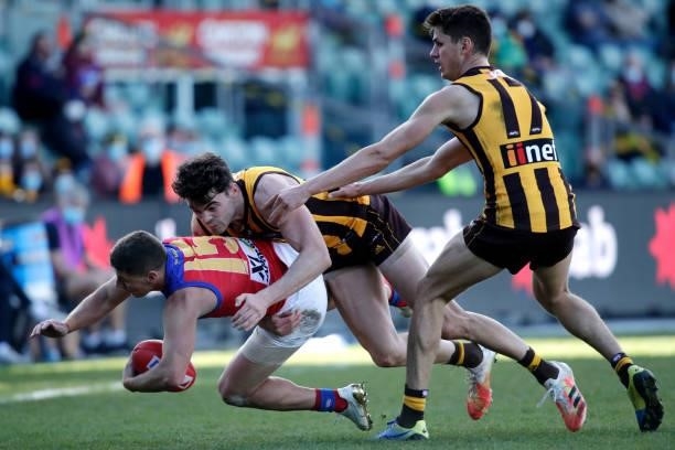 Dayne Zorko of the Lions is tackled by Conor Nash of the Hawks during the 2021 AFL Round 20 match between the Hawthorn Hawks and the Brisbane Lions...