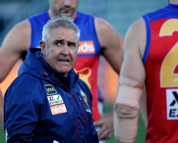 Chris Fagan, Senior Coach of the Lions addresses his players during the 2021 AFL Round 20 match between the Hawthorn Hawks and the Brisbane Lions at...