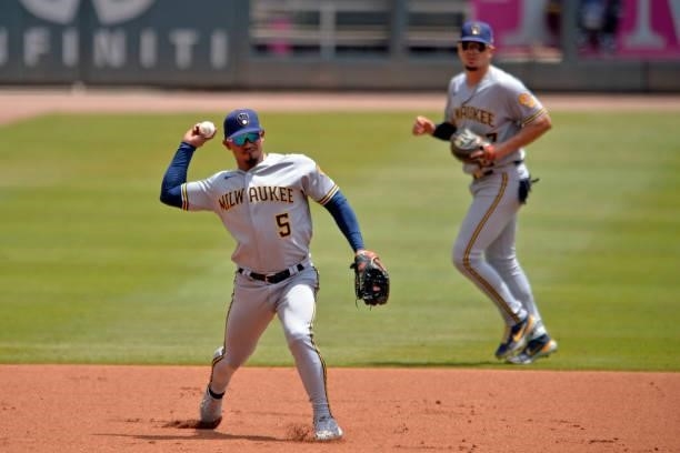 Eduardo Escobar of the Milwaukee Brewers throws to first base in the second inning against the Atlanta Braves at Truist Park on August 1, 2021 in...