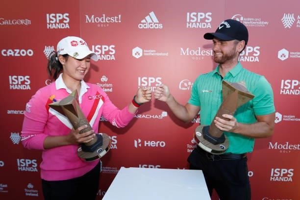 Pajaree Anannarukarn of Thailand and Daniel Gavins of England fist bump with their trophies during the final round of the ISPS HANDA World...
