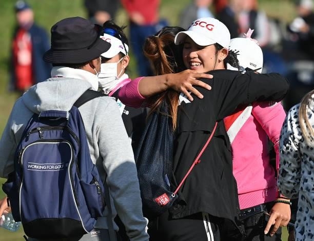 Parjaree Anannarukarn of Thailand celebrates with her family and friends after holing the winning putt at the ISPS HANDA during Day Four of The ISPS...