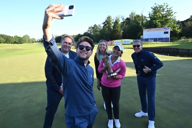 Pajaree Anannarukarn of Thailand poses for a selfie with Niall Horan with the trophy after her victory on the second playoff hole during the final...