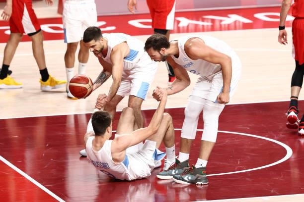 Nicolas Brussino of Team Argentina is helped up by his teammates during the game against Japan at Saitama Super Arena during the 2020 Tokyo Olympics...