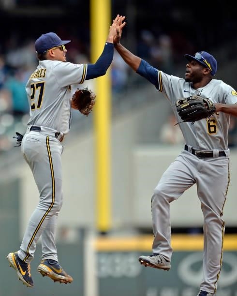 Willy Adames and Lorenzo Cain of the Milwaukee Brewers celebrate after winning against the Atlanta Braves at Truist Park on August 1, 2021 in...