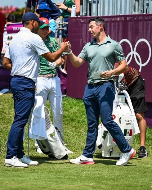 Rory McIlroy of Team Ireland greets Sebastian Munoz of Team Colombia and Carlos Ortiz of Team Mexico on the first tee during the final round of Mens...
