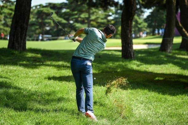 Rory McIlroy of Team Ireland punches a shot from the rough on the 15th hole during the final round of Mens Individual Stroke Play Golf on day nine of...